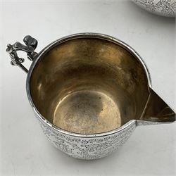 Late Victorian silver bachelors three piece tea service, comprising bullet shaped teapot, open sucrier and milk jug, each engraved with monogram surrounded by birds upon and amidst a blossoming vine, the teapot with scroll capped curved wooden handle and wooden finial to cover, hallmarked Wakely & Wheeler, London 1890, teapot including handle H12cm, sucrier H5.5cm 