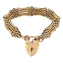 Early 20th century rose gold gate bracelet with engraved heart locket clasp, maker's mark W.J.S, stamped 9ct 