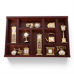 Large collection of miniature novelty clocks, including examples modelled as ships, a lamp, handbag, sewing machine, lamp etc 