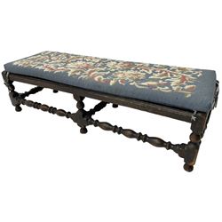 Early 20th century oak framed turned footstool, rectangular cane top, with loose cushion in tapestry upholstery