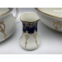 Early 20th century Bishop and Stonier four piece toilet set, comprising washbowl, wash jug, toothbrush pot, and chamber pot, each  decorated with deep blue band and husk swags and festoons in gilt, with printed Caduceus Bisto marks beneath and printed retailers mark 'Manufactured for Harrods Limited London', wash bowl D43cm, wash jug H31.5cm