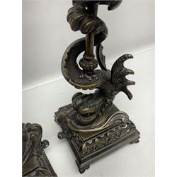 Pair of late 19th/ early 20th century brass candlesticks in the form of dolphins upon a stepped base with Fleur-de-lis design, H32cm 
