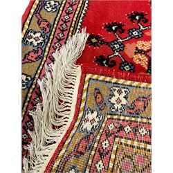 Small Persian Arak rug, red ground and decorated all-over with Boteh motifs (90cm x 56cm); a similar larger Persian Arak (126cm x 60cm); and a Persian red ground rug with extending stylised flower head design (123cm x 60cm)