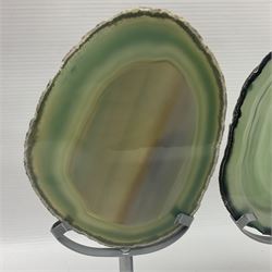 Pair of green agate slices, polished with rough edges raised upon silvered metal stands, H19cm