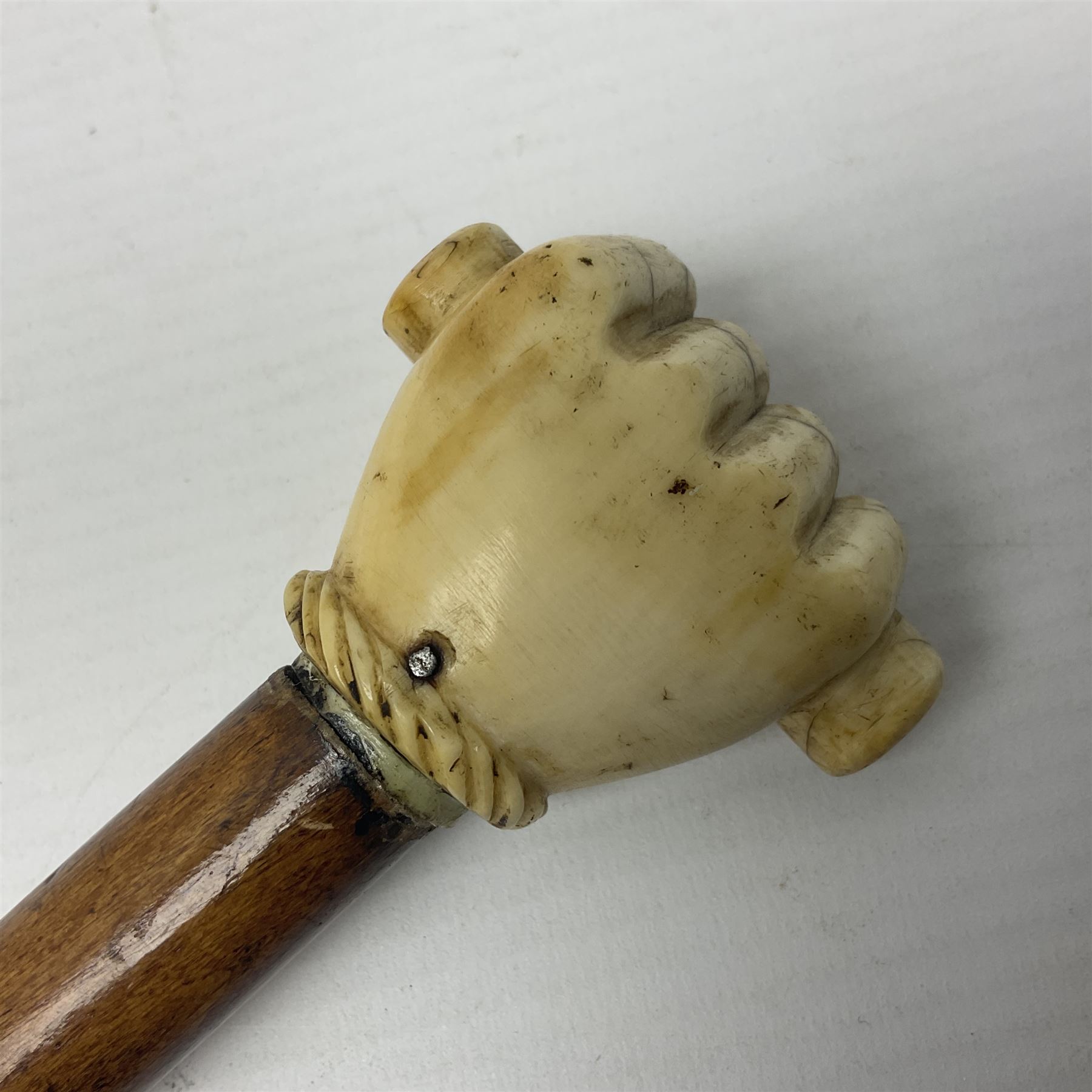 19th century malacca walking cane with scrimshaw handled in the form of a clenched fist holding a scroll, H86cm 