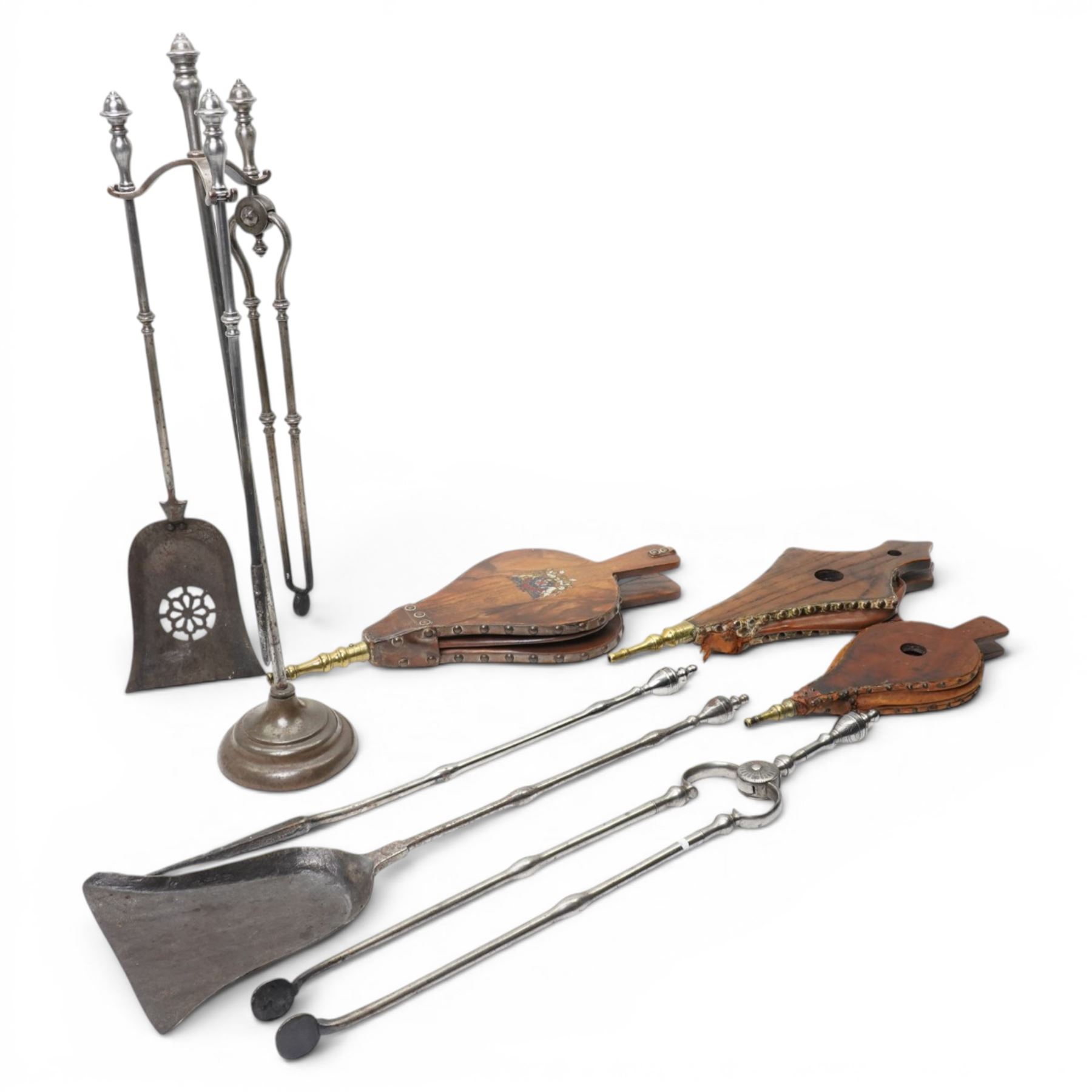 19th century fireside three piece fireside companion, H69cm; together with three further fire irons, and three bellows, one set with crest 
Provenance: Kirkham Hall
