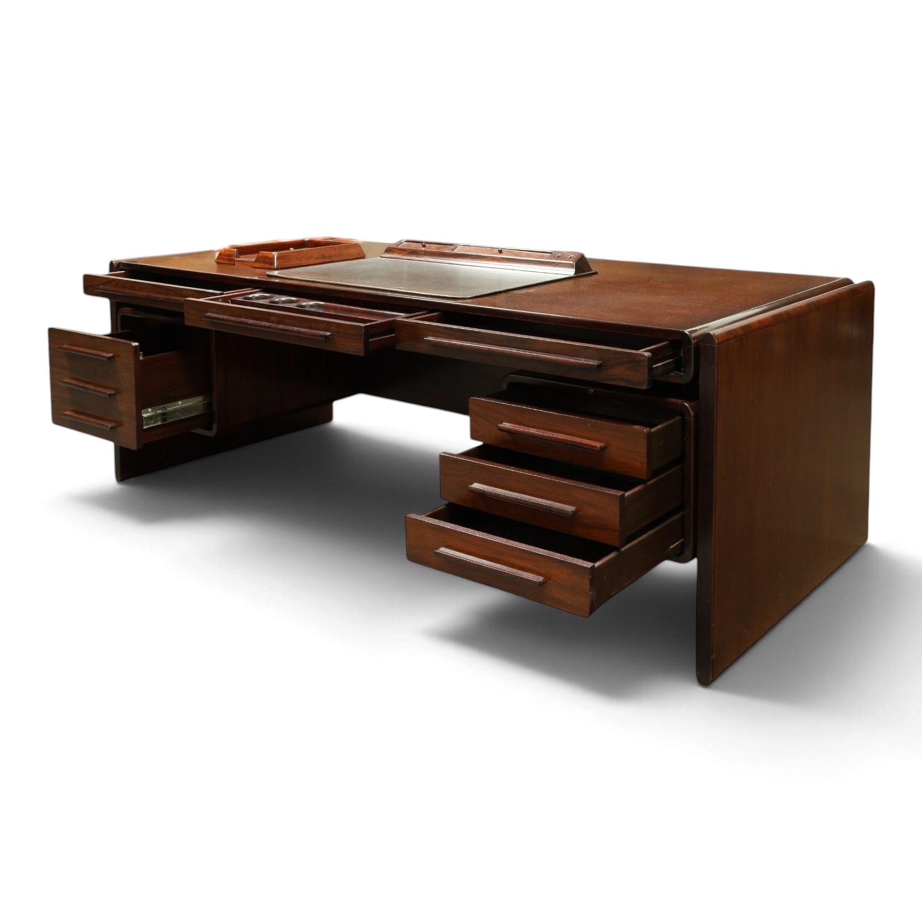 Dyrlund - Santos rosewood office suite, comprising an executive desk and cream leather upholstered swivel chair, the desk with a broad rectangular top with rounded corners, leather writing surface, pen compartments and letter tray, three lockable frieze drawers with fitted interiors above a central kneehole flanked by floating drawer pedestals, the left housing a filing drawer and the right three compartmented drawers, with a full width modesty panel to the reverse, chair raised on a castor base, H 116cm, W 62cm, D 74cm