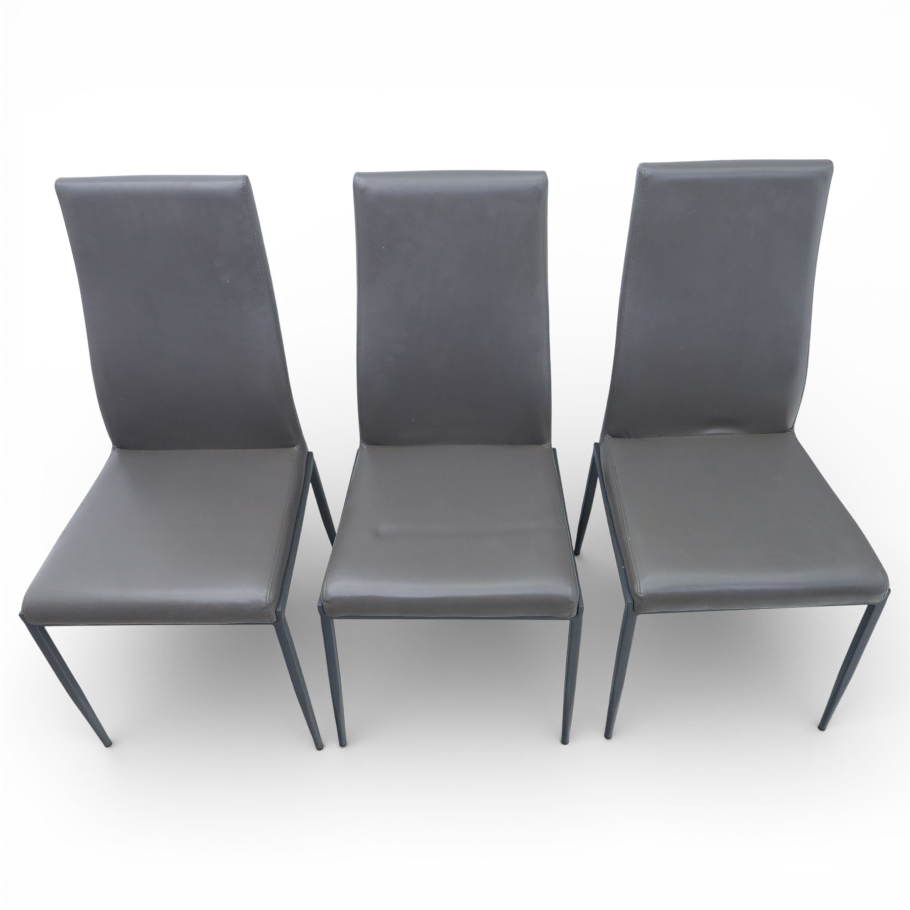 Modern composite marble effect dining table, rectangular top with simulated veining supported on a block pedestal base, accompanied by six matching dining chairs with padded seats and backs in grey upholstery on slim metal legs