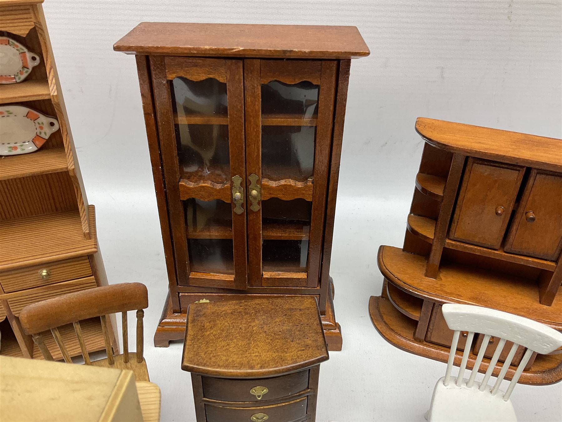 Doll's house wooden furniture - over twenty items including good quality pine Welsh dresser by Tony of Lincoln; tall 'glazed' bookcase; two-tier side cabinet; grand piano; bedside chest, mule chest, Canterbury; cradle; Georgian style hanging corner cupboard; dumb waiter; tables; chairs; rocking chair etc; various scales
