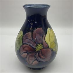Moorcroft Clematis pattern vase of baluster form, upon a blue ground, with painted and impressed marks beneath, H22cm