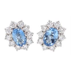 Pair of 18ct white gold oval aquamarine and diamond cluster stud earrings, hallmarked, total aquamarine weight approx 1.55 carat, total diamond weight approx 0.90 carat