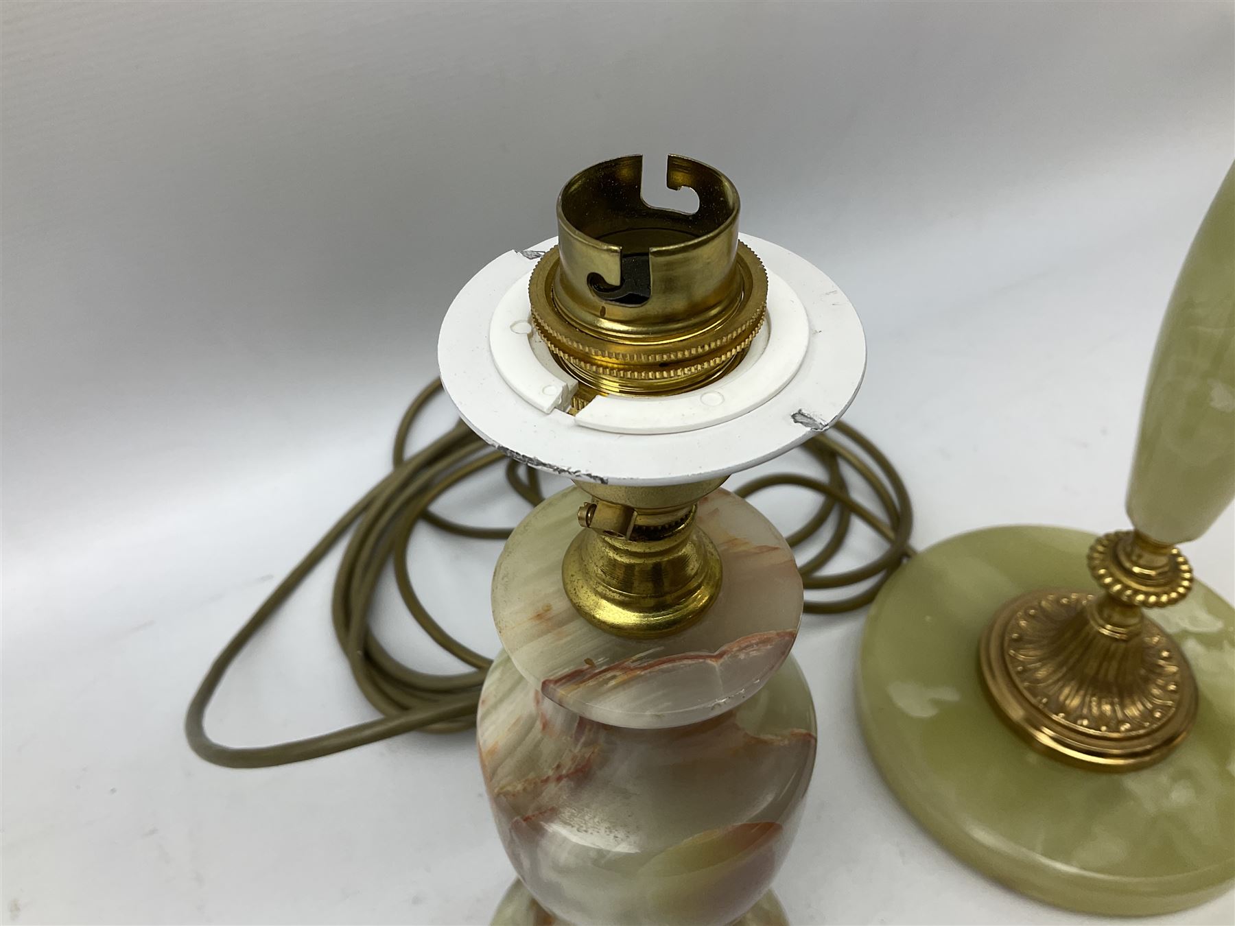  20th century gilt metal and onyx four branched candelabra upon a circular base, and onyx table lamp in the form of an urn, tallest example H48cm