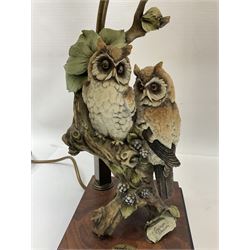 Two Giuseppe Armani figural lamps, the first modelled as an owl perched upon a book, the second modelled as a pair of owls perched upon blackberry branch, each with damask fabric tassel shades, tallest H76cm
