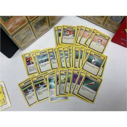Collection of Pokemon trading cards, mostly 1999 Wizards Pokemon cards to include holo Charizard 4/102, first edition holo Machamp 8/102, further holographic cards; Dark Flareon 35/82 and Dark Vaporeon 45/82, cards from themed sets and 4th edition prints; 1998 Electronic Pokédex with cardboard boxes for themed decks Blackout, Overgrowth and Power Reserve Jungle, along with a large quantity of energy and trainer cards 