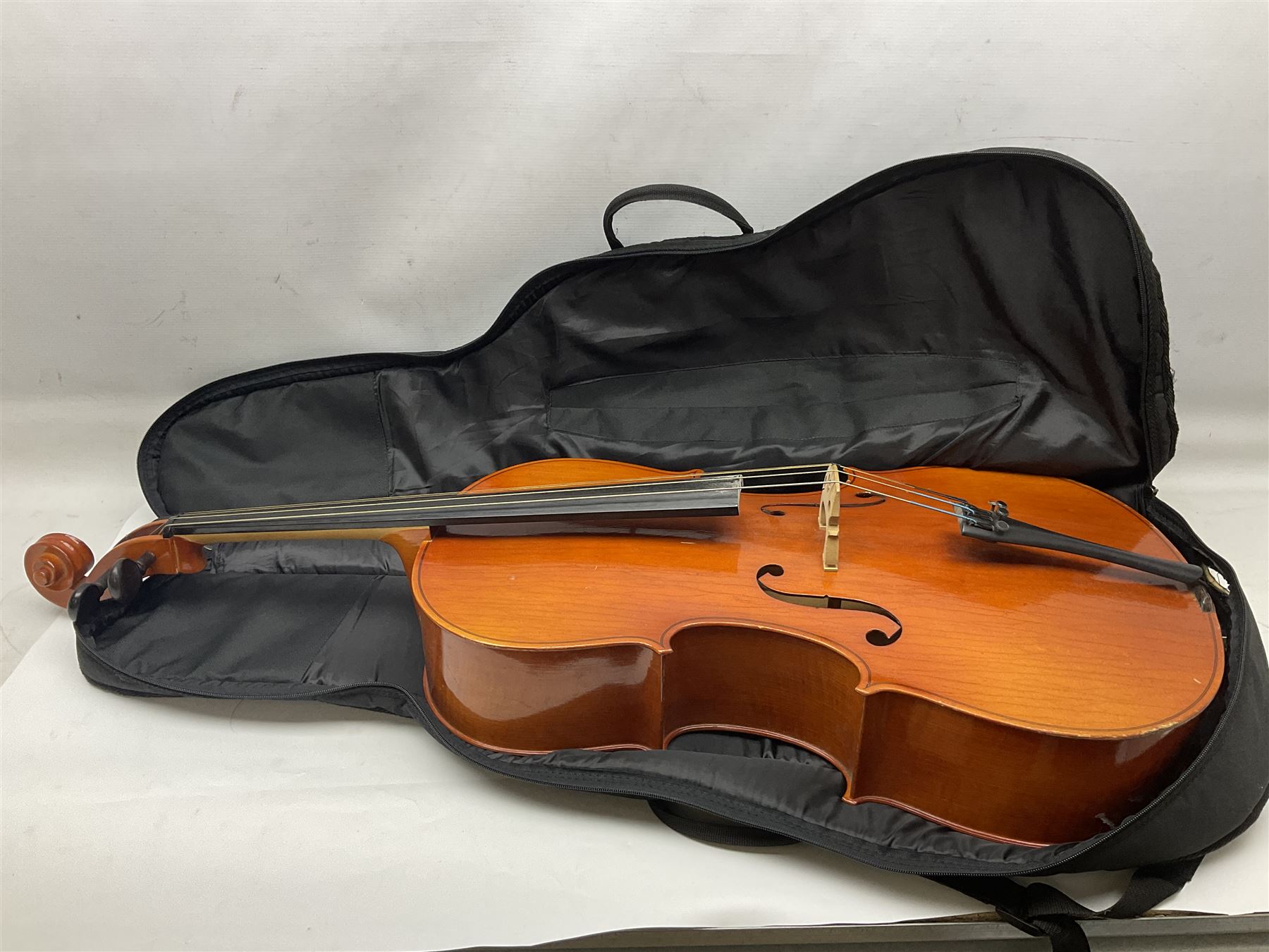 Modern Hungarian half-size cello with 69cm two-piece maple back and ribs and spruce top L114cm overall; and Stentor half size cello bearing label 'The Stentor Student II'; each in soft carrying case (2)