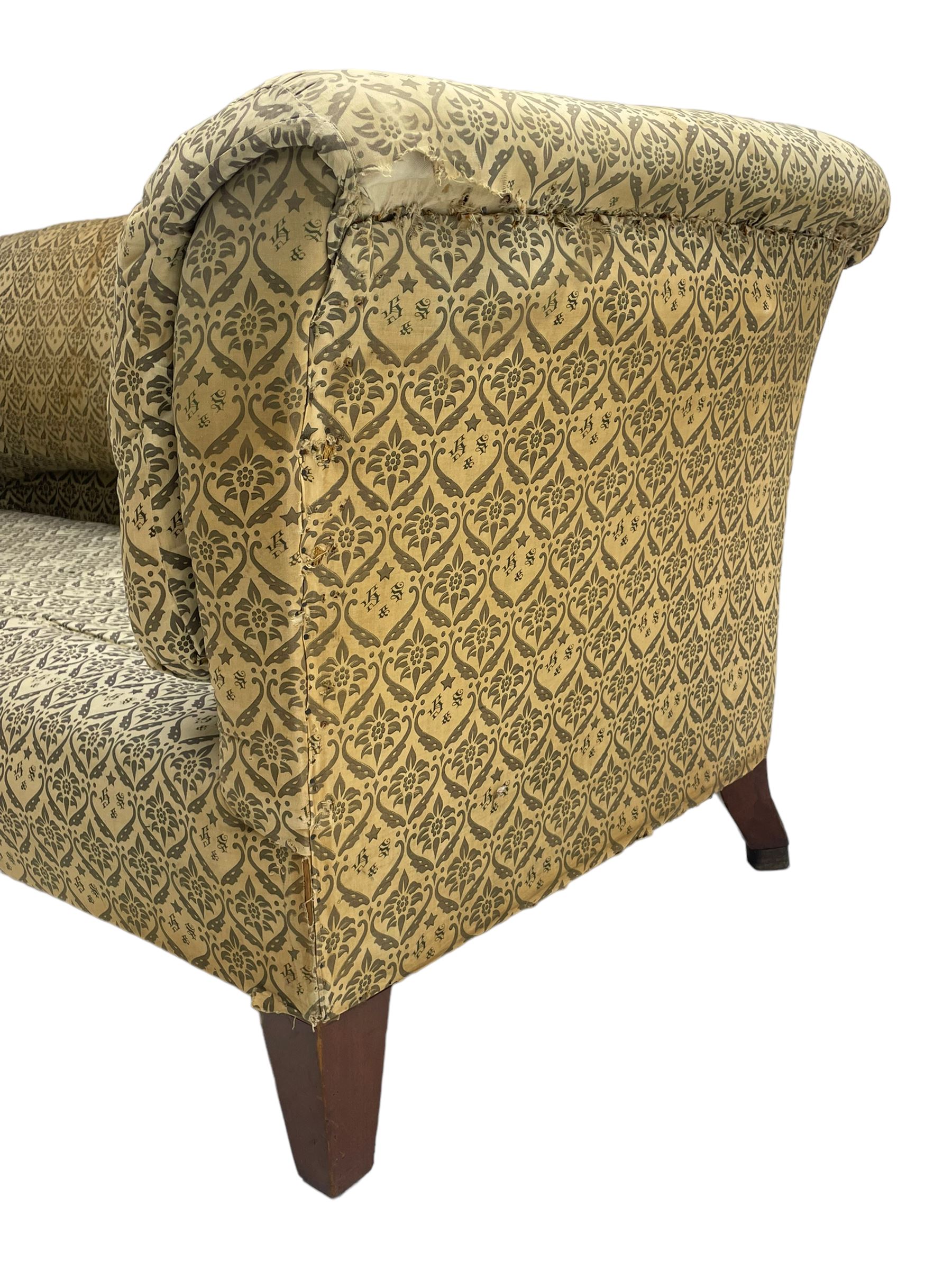 Howard & Sons - Edwardian mahogany framed two seat sofa, upholstered in original H&S foliate patterned fabric with sprung seat and overstuffed back and arms, raised on square tapering supports, the rear leg stamped '19600 1795 Howard & Sons Ltd Berners Street'