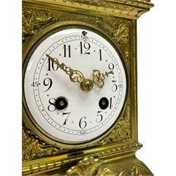 A French twin train striking mantle clock c1890 in a brass case with a decorative plinth raised on four paw feet, pediment with an elongated dome and finial within a raised and crested gallery, matching lion mask carrying handles to the sides, with an enamel dial, upright Arabic numerals , minute track and gilt Louis XV hands within a convex glazed brass bezel, eight day striking movement striking the hours and half hours on a coiled gong. With pendulum.

