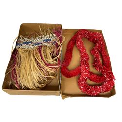Mid 20th century Hawaiian grass hula skirt, the waistband adorned with various shells, together with two red leis