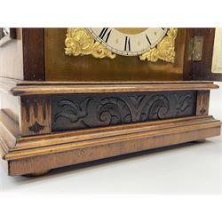 Late 19th century walnut cased mantel clock, sloped arch and cavetto top pediment carved with flower heads, the brass dial with silvered Roman chapter ring decorated with shell and scroll cast spandrels, enclosed by bevel glazed and moulded door, the lower frieze carved with foliate scrolls, on stepped moulded base, twin train driven eight day movement with ting-tang strike, striking the hours and quarters, movement back plate stamped 'RMS' for Schnekenburger