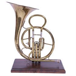 Boosey & Co Ltd French horn, converted into a table lamp, upon a wooden plinth, H45cm