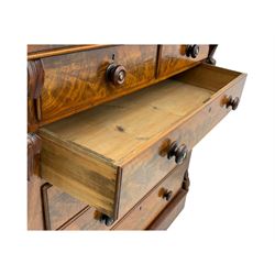 19th century flame mahogany Scotch chest, frieze long drawer above two short and four long graduating drawers, with turned knobs scrolled carved side bracket 