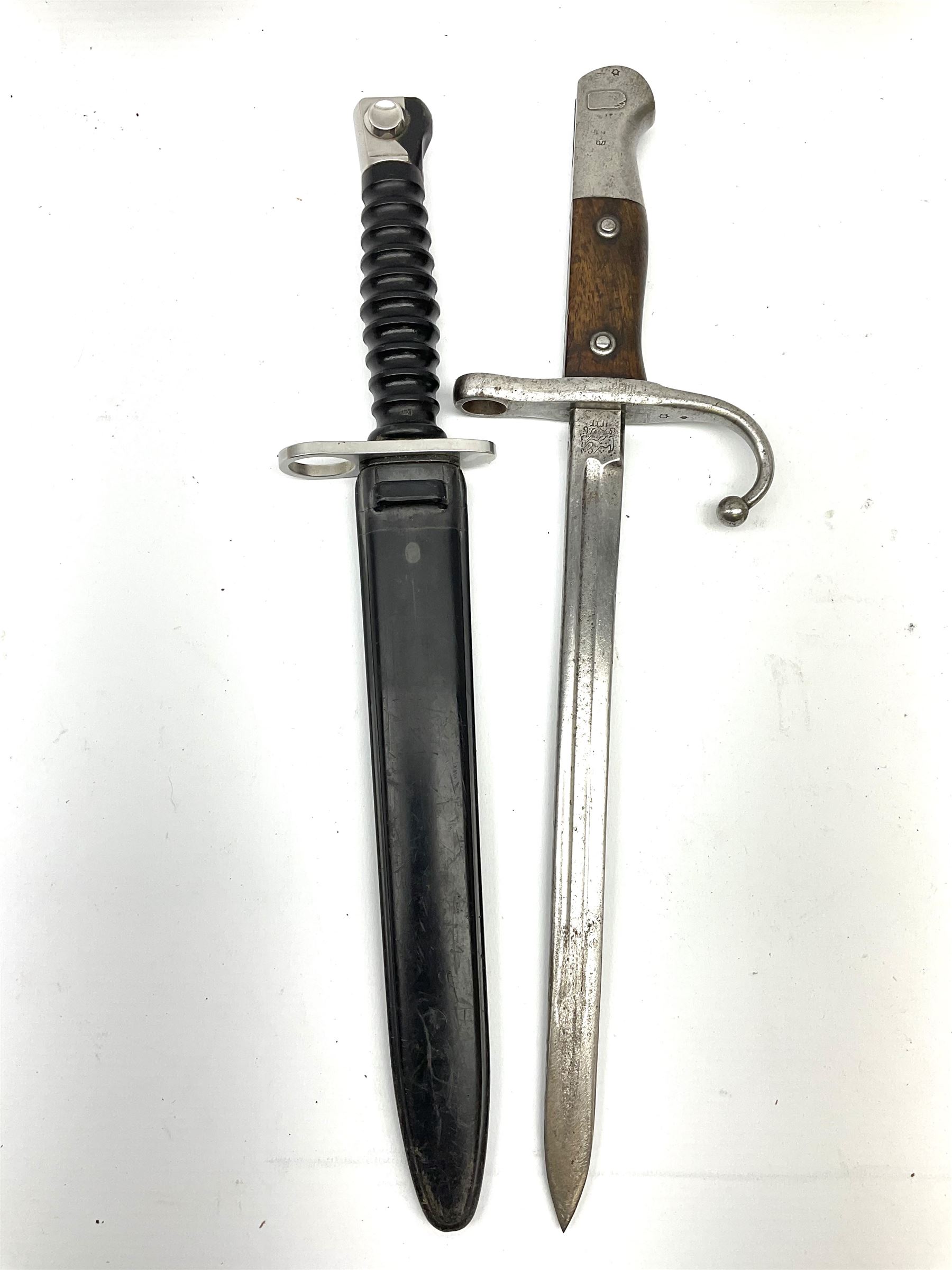 Swiss M1957 S.1.G. assault rifle bayonet, the 24cm double edged blade marked 'F over +W' for Waffenfabrik Bern and W343723, ribbed black grip and plastic scabbard L38cm; and cut down WW1 Turkish Mauser 1890/1903 pattern sword bayonet with numerous Ottoman Turkish Army marks, blade 26.5cm (Pommel has Ottoman Sultan's seal 'Tughra' - the same as on the Gallipoli Star awarded to Turks after the Gallipoli Campaign)
