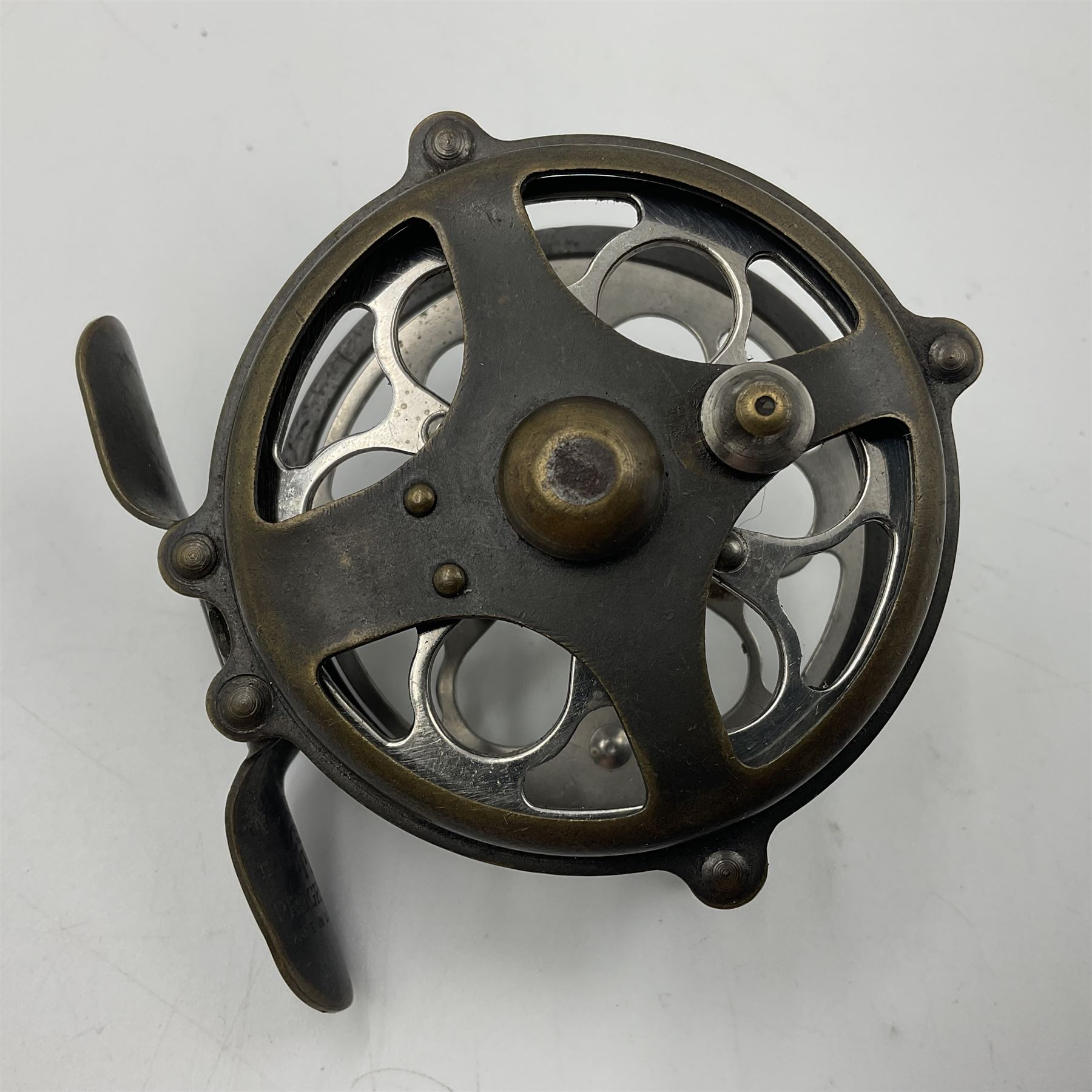 TO RTV Three fishing reels, including American Pflueger progress bulldog size 60 brass and chrome skeleton fly reel, with wooden handle; Maginot 106 fly reel and an alloy reel (3)