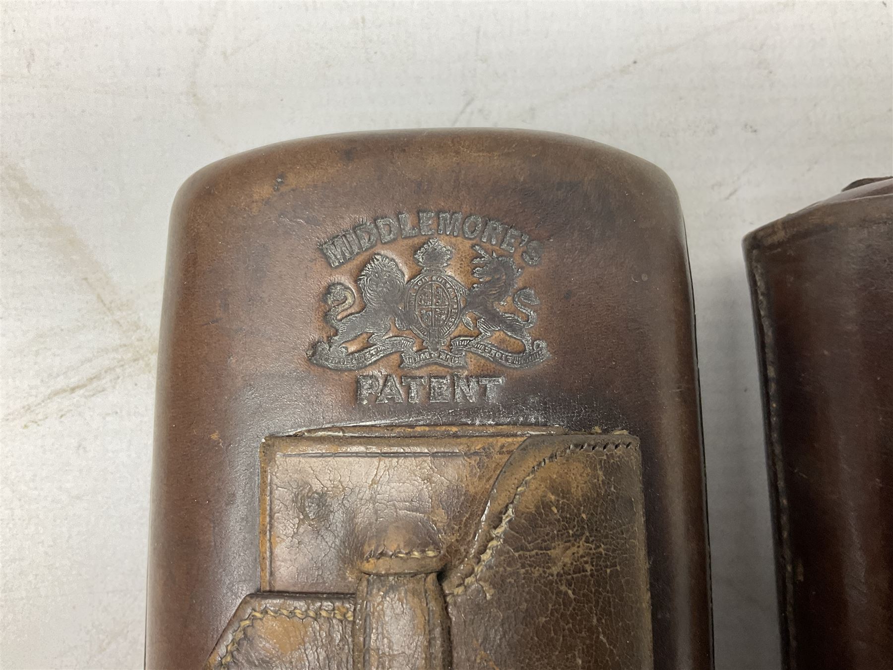 Victorian leather cigar protector with metal match striking plate on the end and internal spring to hold the cigars in place; expands for differing lengths of cigar, minimum L12.5cm; another similar leather cigar case marked Middlemore's Patent with attached vesta case and striker; three Bryant & Mays tin-late matchbox holders including 1935 Jubilee; and small box of matches (6)