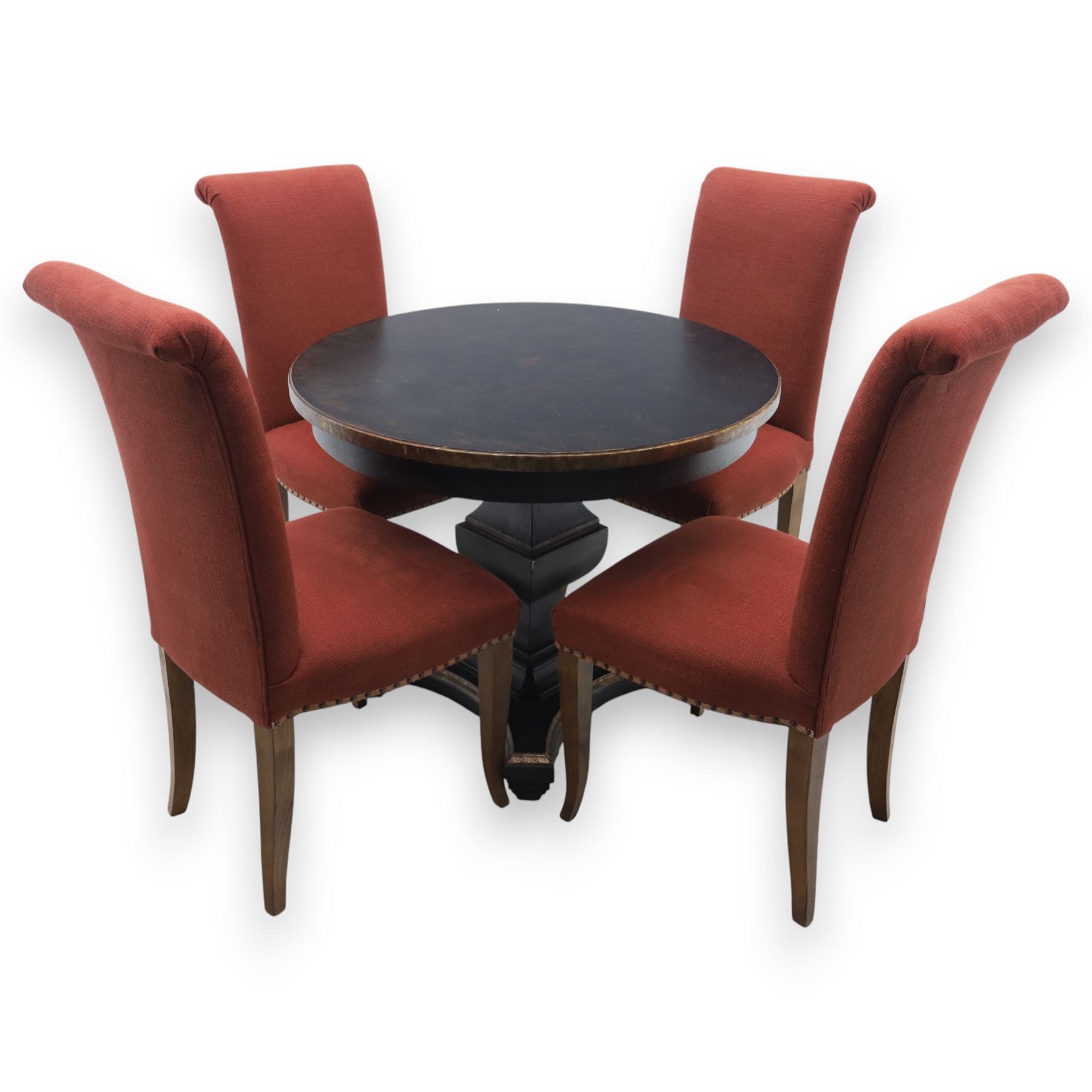 Contemporary circular painted dining table and four red upholstered chairs, table with distressed finish in black with quatriform base and bronze painted edges, chairs with 