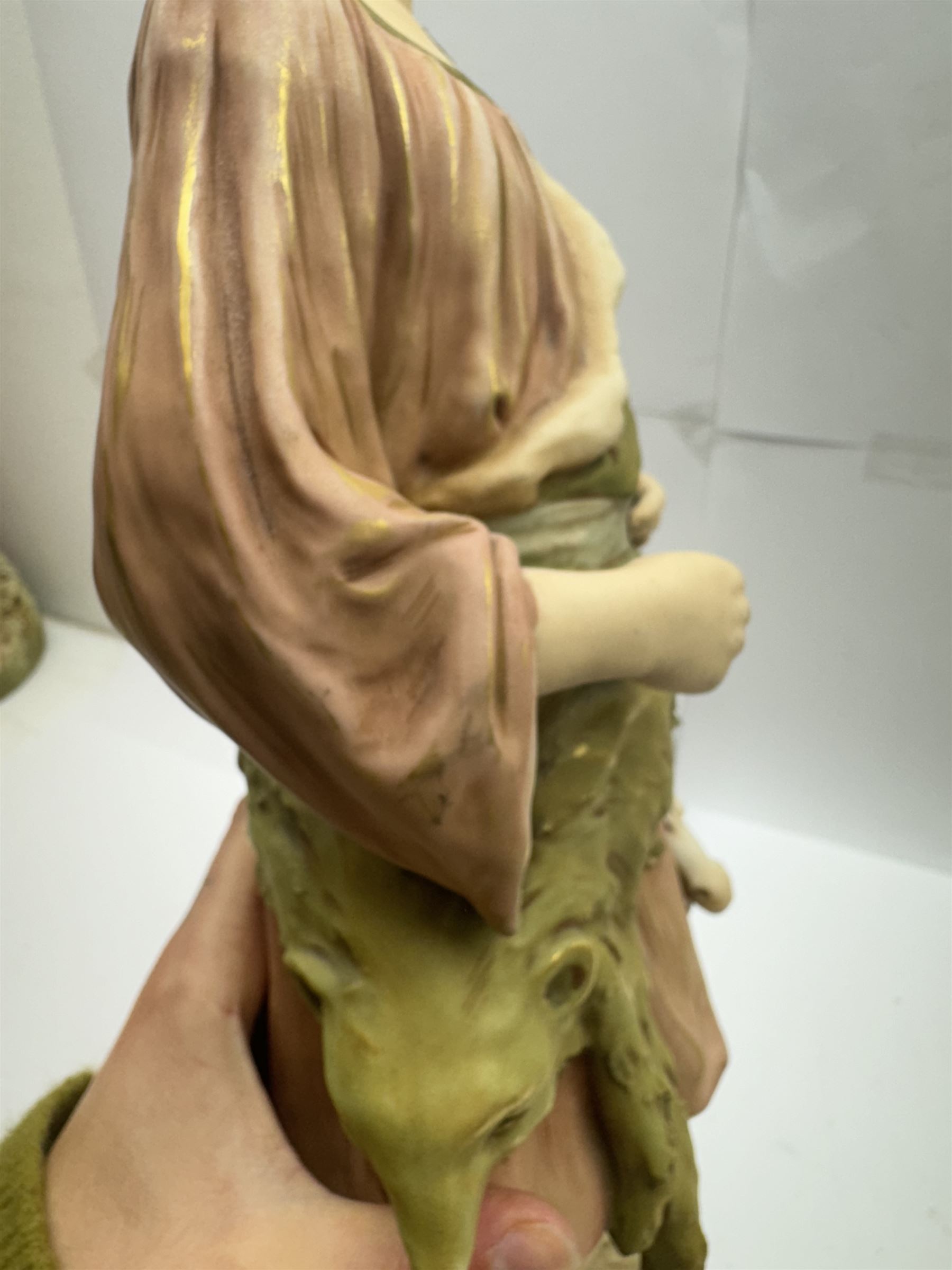 Pair of Royal Dux figures, no. 1115, modelled as a shepherd with a goat by his side and a shepherdess feeding a lamb, each wearing flowing green and pink robes with gilt detailing, with pink triangle mark beneath, H51cm