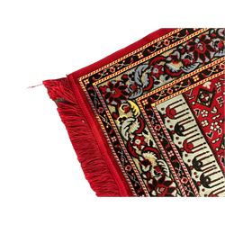 Turkish crimson and light blue ground prayer rug, the field decorated with stylised plant motifs, scrolling foliage pattern border 