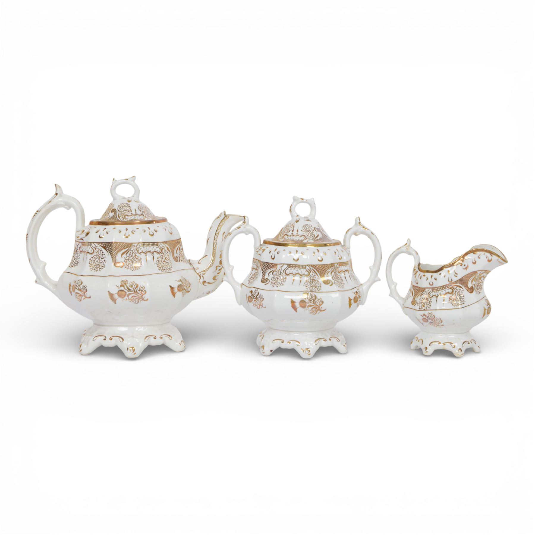 Late 19th century tea service, decorated in gilt with bands of seaweed type tendrils, thistles and cross hatch reserves upon a white glazed ground, comprising tea pot, twin handle lidded sucrier, milk jug, slop bowl, three serving plates, twelve cups and saucers and eleven side plates