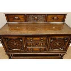  Early 20th century oak sideboard, raised back with relief carved strap work decoration, three drawers and two cupboards with geometric panels, barley twist supports connected by stretchers, W159cm, H118cm, D57cm  