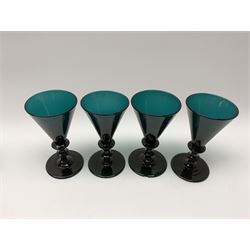 19th century green glass ships decanter with flat topped stopper, H21.5cm, together with a set of four 19th century green glass wine glasses, the funnel bowls upon bladed knopped stems and circular feet, H13cm