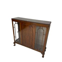 Late 20th century mahogany display cabinet, moulded and foliate carved rectangular top, enclosed by central figured door flanked by two glazed doors, scroll and acanthus carved ball and claw feet