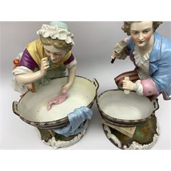 Pair of 19th century Continental porcelain figures, possibly German, modelled as a washerwoman and workman, each modelled stood over a wooden tub, upon naturalistically modelled circular base with C scroll detail, blue underglaze mark beneath, tallest example H30cm
