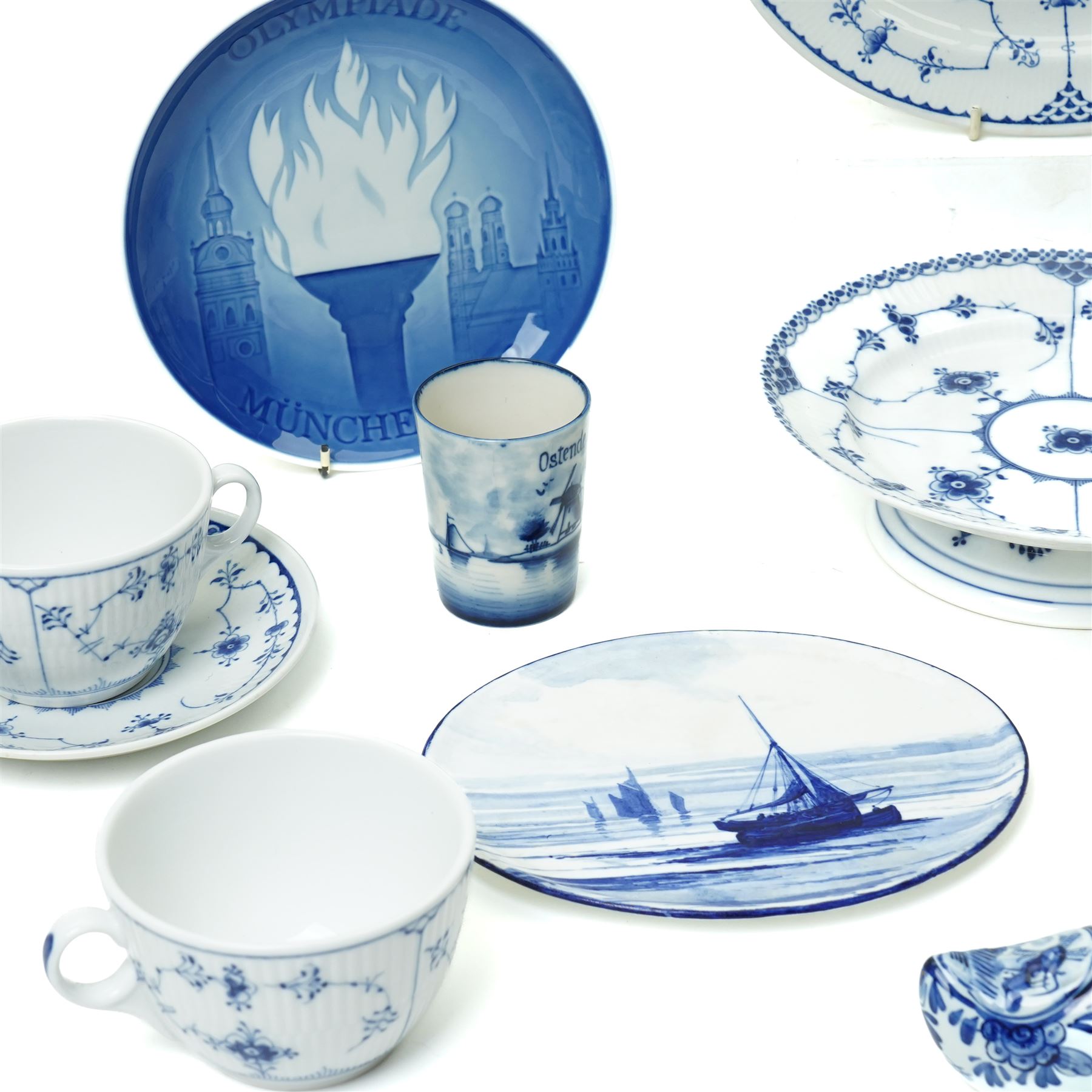 Royal Copenhagen onion pattern low comport, three breakfast cups and five saucers, oval platter, four tea plates, Munich 1972 Olympics plate, and four other blue and white items