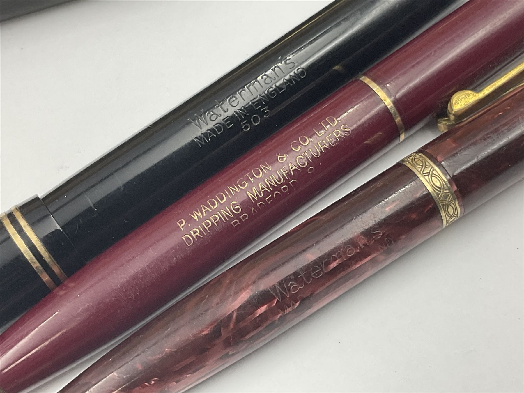 Group of Waterman pens and propelling pencils, to include a fountain pen, the black barrel with rolled gold cap and nib stamped 14ct, together with a matching propelling pencil, in box, together with a further fountain pen with gold nib stamped 14ct, stainless steel fountain pen and rollerball set in box, propelling pencil with maroon barrel etc, largest L13cm (7)