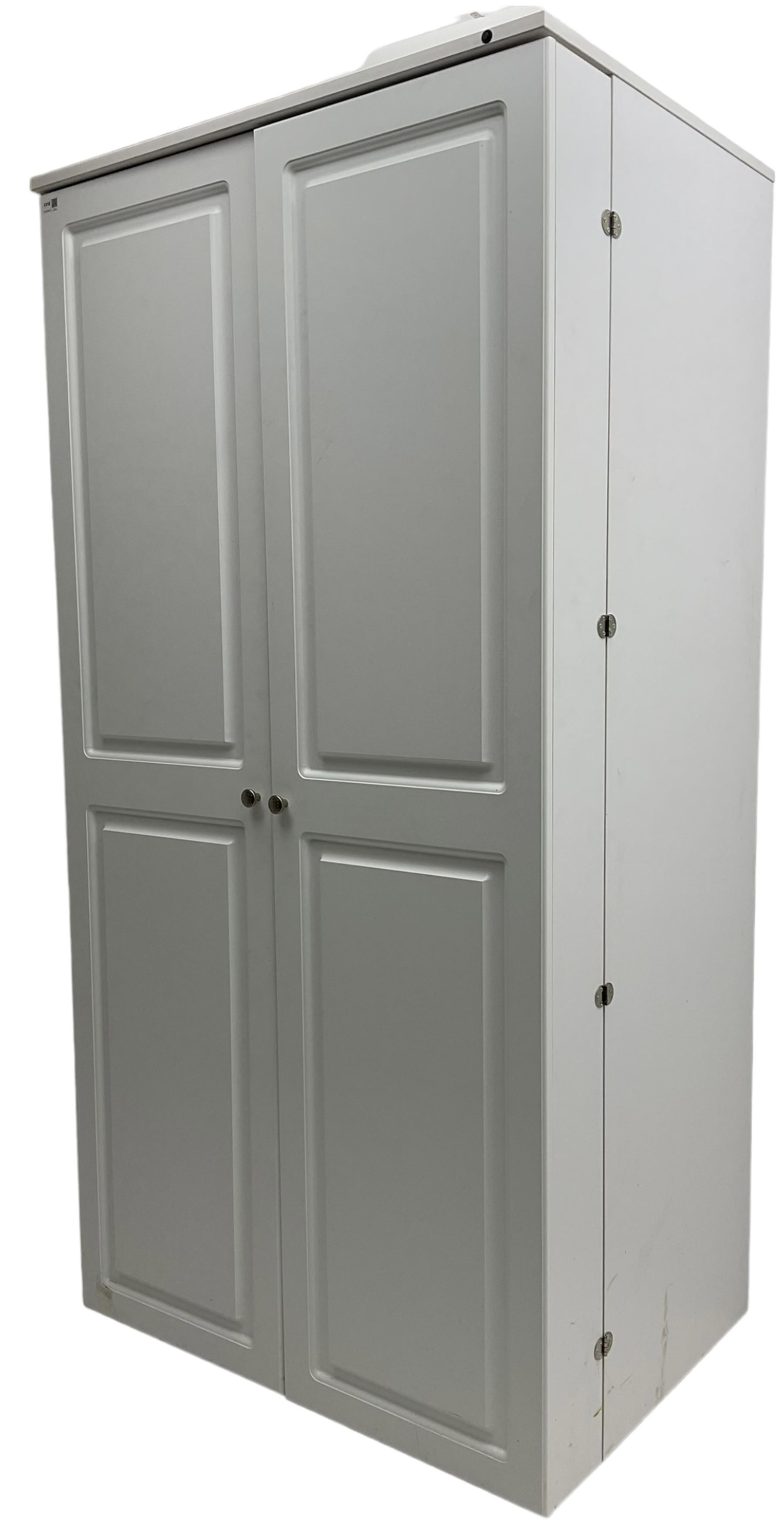 Large white finish sewing cabinet, enclosed by two doors fitted with thread holders and shelves, the interior fitted with shelves and sliding trays, with fold down work surfaces 