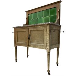Edwardian oak washstand, raised green tiled back above rectangular marble top, fitted with double cupboard below, on tapering supports with castors