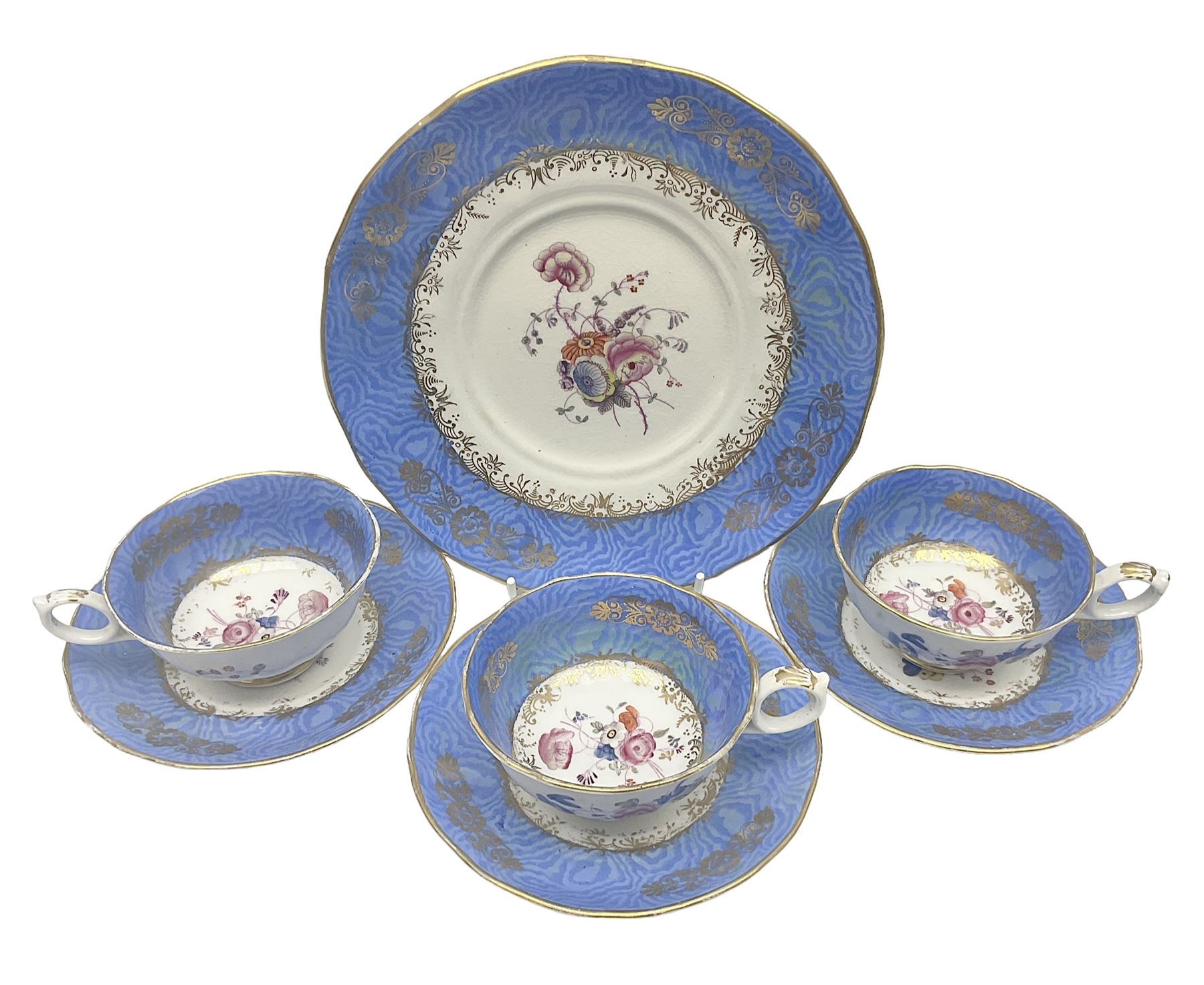 Set of three Victorian teacups and saucers, with matching dessert plate, decorated with a watered silk blue boarder and hand painted floral sprays to the centre 