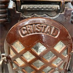 Deville & Cie of Charleville - early 20th century Art Deco cast iron and burgundy enamel 'Cristal' wood burning stove, hinged vent over lattice glazed door and ash drawer, on shaped geometric base, circa 1920