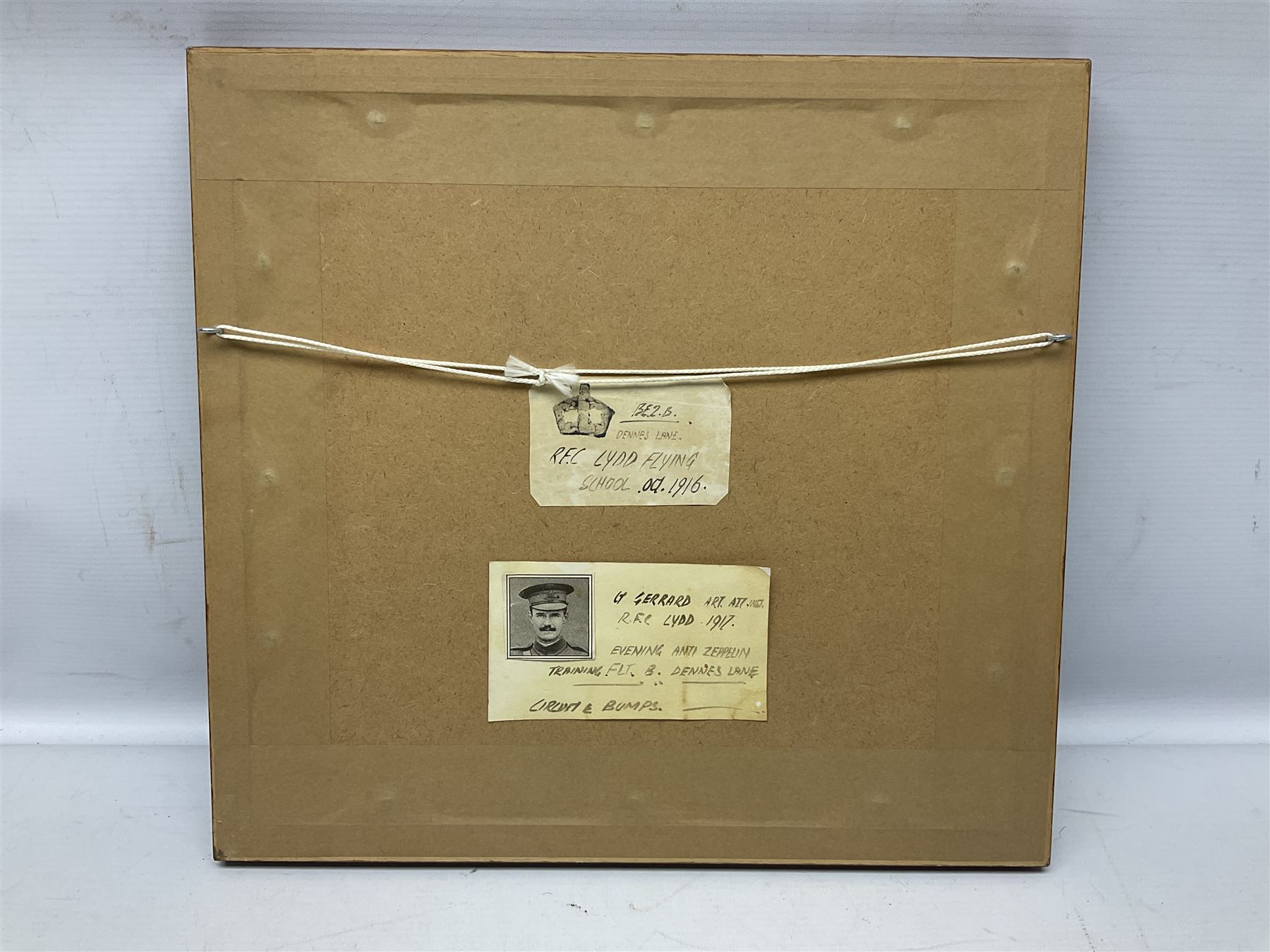 T. Page (early 20th century) - RFC bi-plane in flight over an airfield, bears labels verso 'BE2.B. Dennes Lane R.F.C. Lydd Flying School Oct.1916' and 'Lt. Gerrard R.F.C Lydd 1917 Evening Anti Zeppelin Training Flt. B. Dennes Lane Circum & Bumps', signed watercolour 20.5 x 22.5cm, later mahogany stained frame