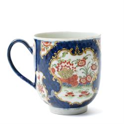 Russian, probably Gardner figure of a man pushing a wheelbarrow on gilt lined rectangular base, impressed mark, H16cm, 18th century creamware beaker with star shape decoration, 18rh century Worcester cup with panels of flowers on a blue ground and a French shell shape scent flask (4)