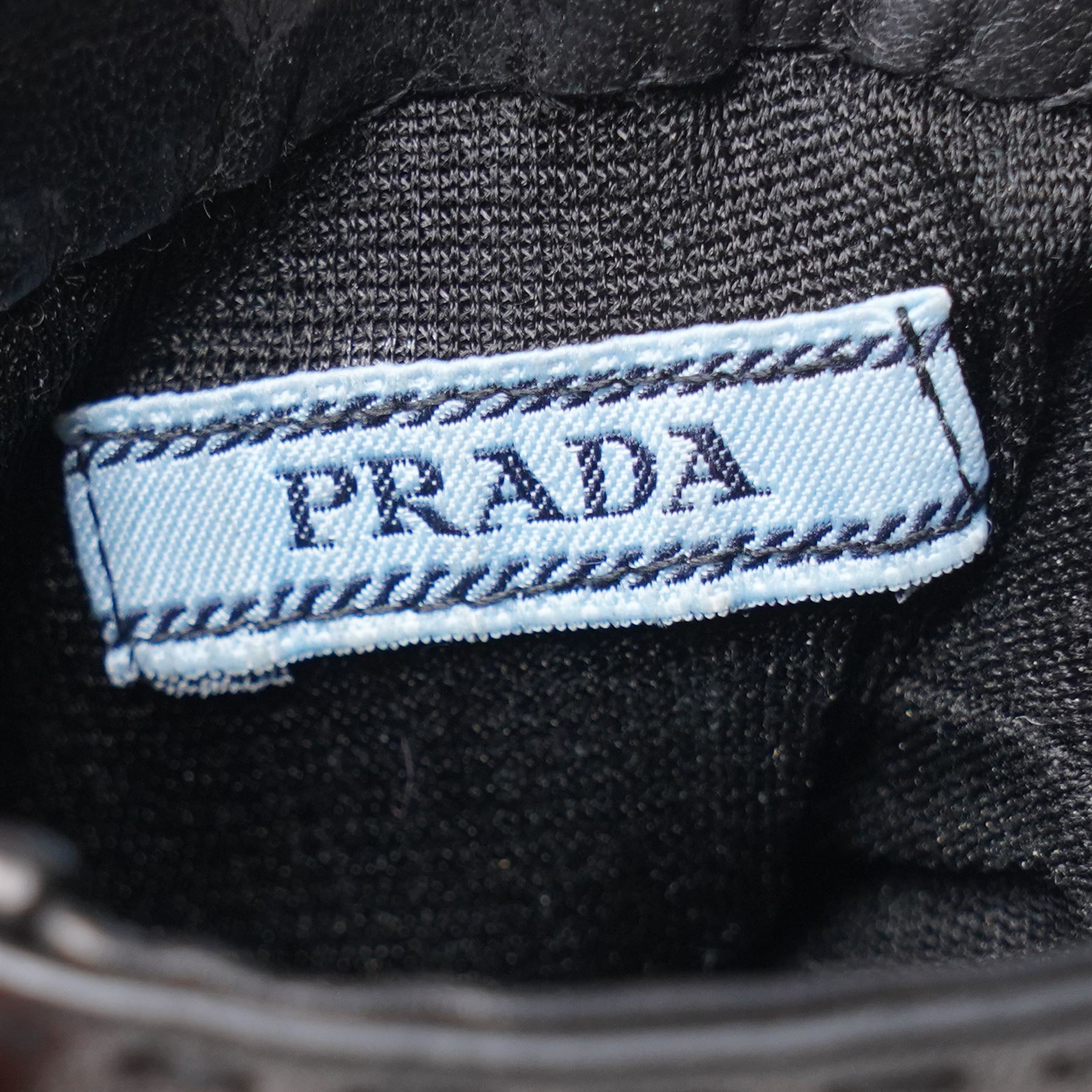 Prada - pair of black lambskin leather gloves, with enamel gold-tone and black triangle logos and silk lined interior, unused with original box
