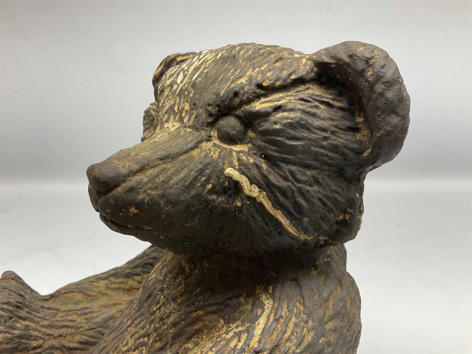 19th century cast iron door stop, modelled as a seated toy bear, with remnants of painted finish, H22.5cm