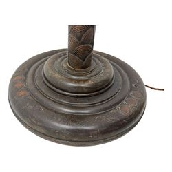 Early 20th century floor lamp, with fringed and pleated silk shade over a carved and turned column, on a circular stepped base