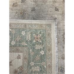 Persian Zeigler rug, ivory ground and decorated with stylised plant motifs, floral design border