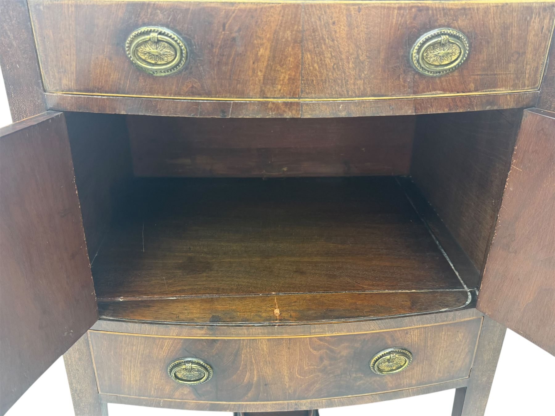 Part canteen of silver plated cutlery, including ivorine handled table and dessert knives, table forks, dessert forks, dessert spoons, teaspoons and soup spoons, all contained within a canteen cabinet converted from a George III mahogany enclosed wash stand