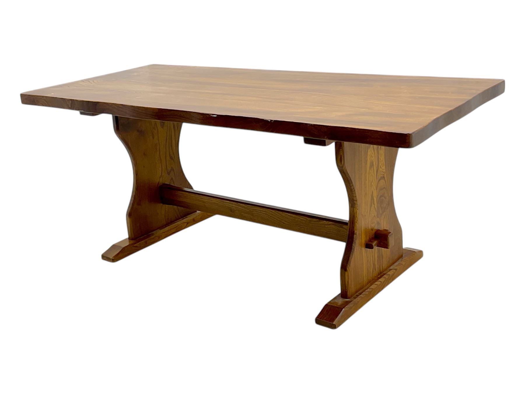 Late 20th century oak trestle table, rectangular top with naturalistic edge, supported by two curved pedestal bases united by central stretcher, on block feet